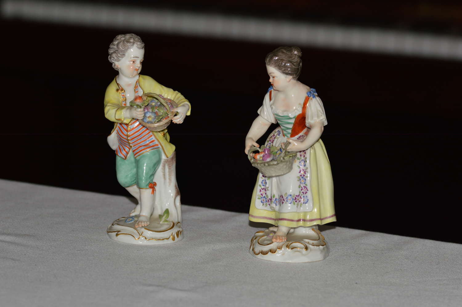 Early 20th century pair of Meissen figurines of a boy and girl